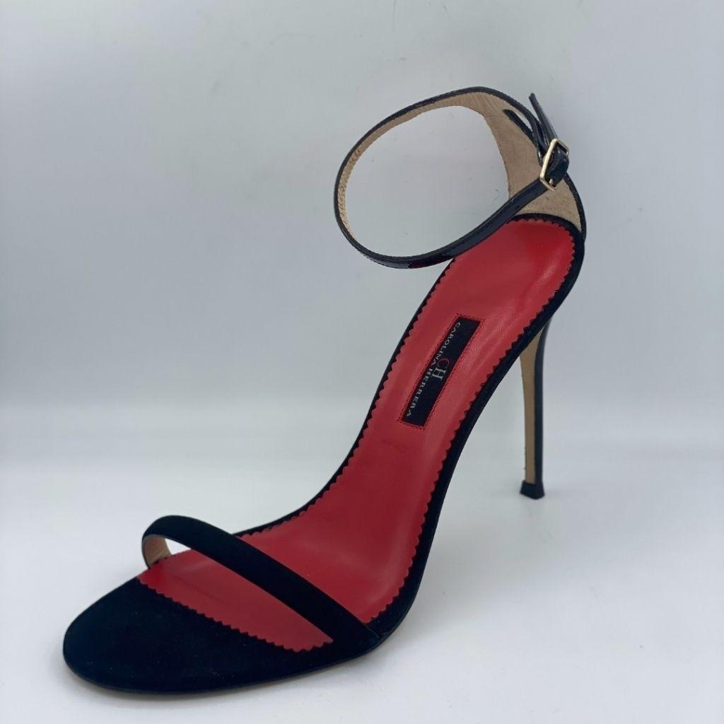 CH Carolina Herrera black suede ankle-strap stiletto sandals with a red sole.